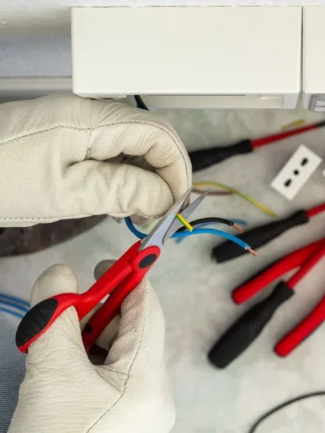 Electrician wiring and wearing personal protective equipment